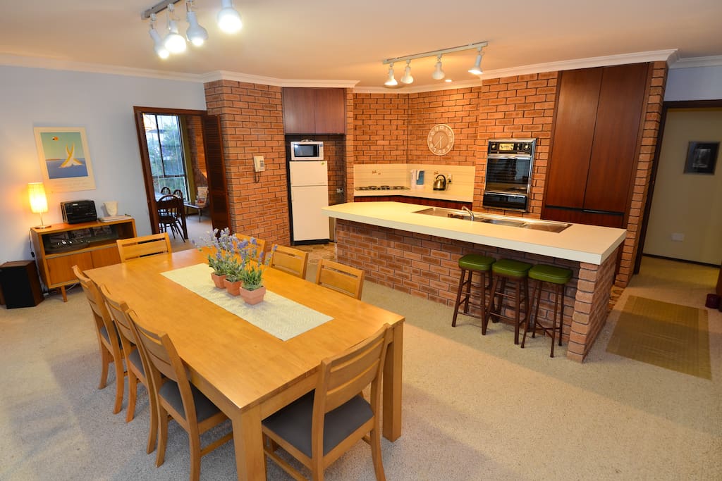 Dining in foreground and kitchen in background