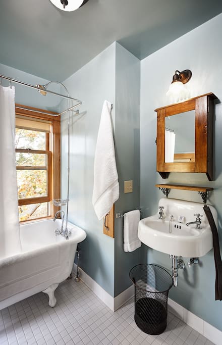 Maple room's private bathroom, claw foot tub with shower