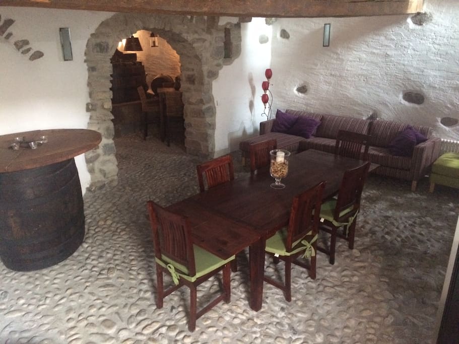 Wine cave with table and door leading to the garden