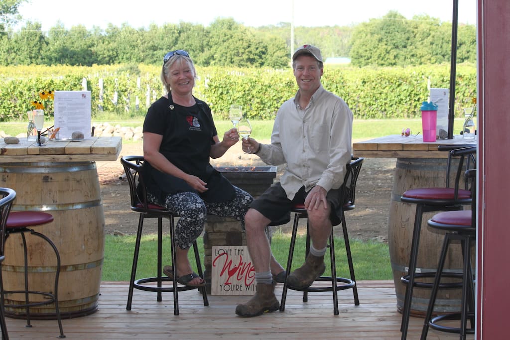 Your hosts sitting on the tasting room patio overlooking the vineyard. Norene and Marc