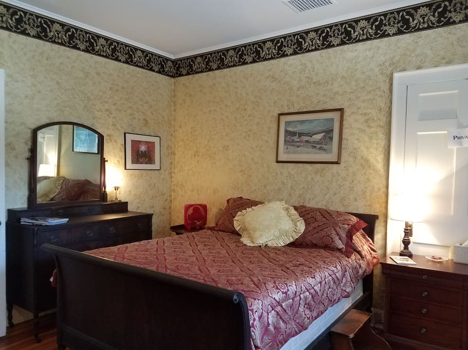 Antique double size sleigh bed with two bedside tables and matching antique dresser