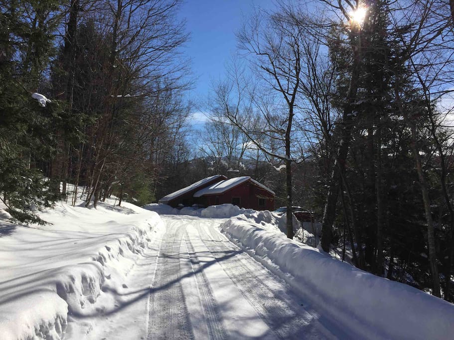 Winter view of house from road. Notice Killington ski trails in background.