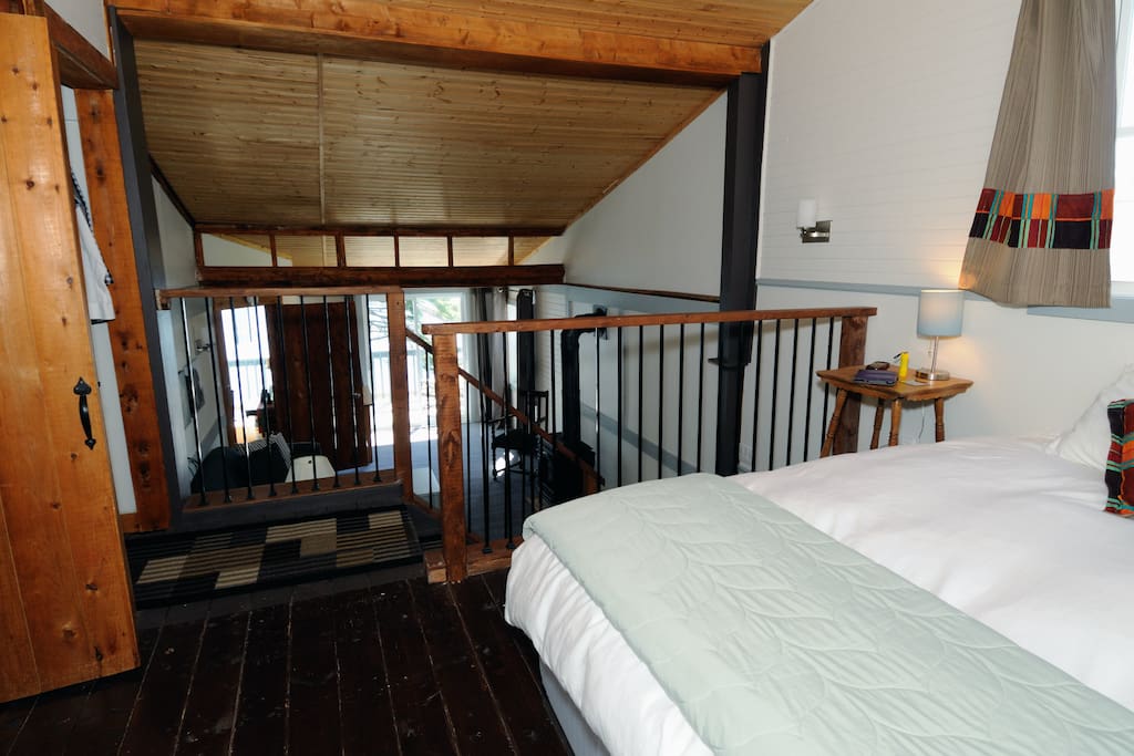 The Loft-like space with king bed, overlooking the private living room area.