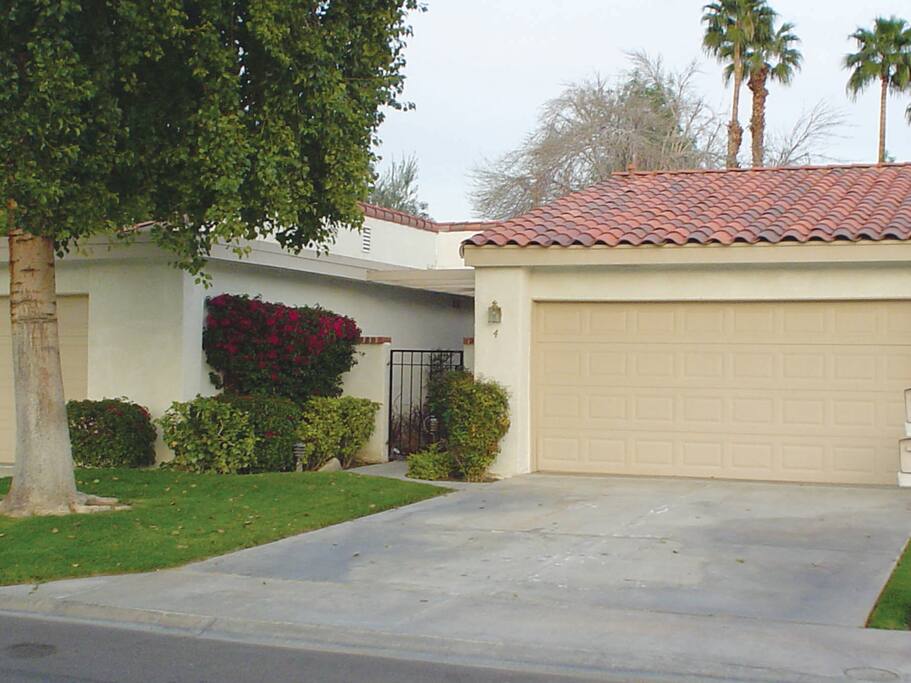 Driveway, garage, and entry way to the condo