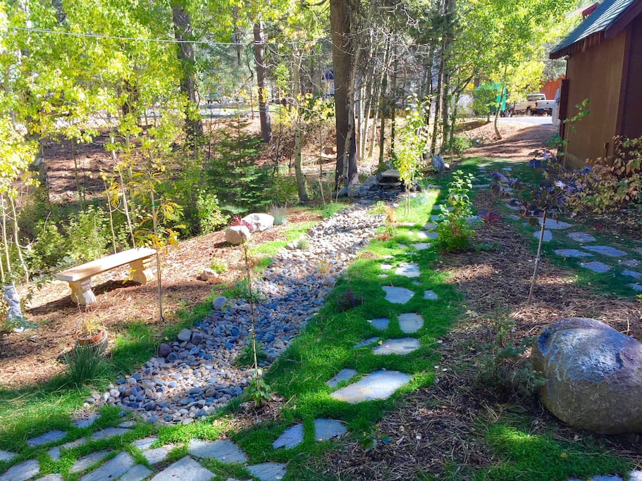 Front walk way with fountain and spring-time creek.