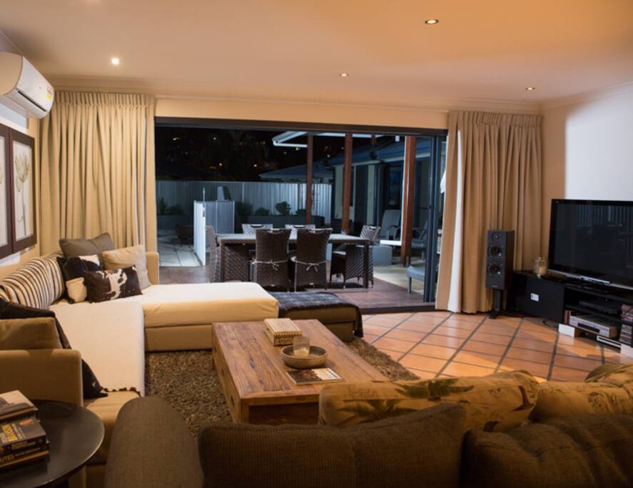 Looking from Kitchen to Living and outdoor Alfresco Area and Pool to left.