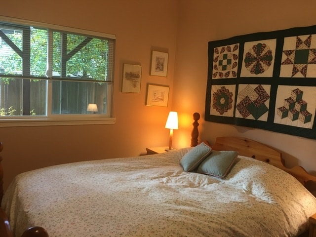 מיטת קווין סייז עם שמיכת פוך, שידה וארון. 