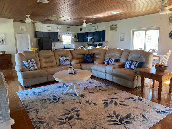 Open concept main living area. Comfy couch with two recliners and sleeper sofa.
