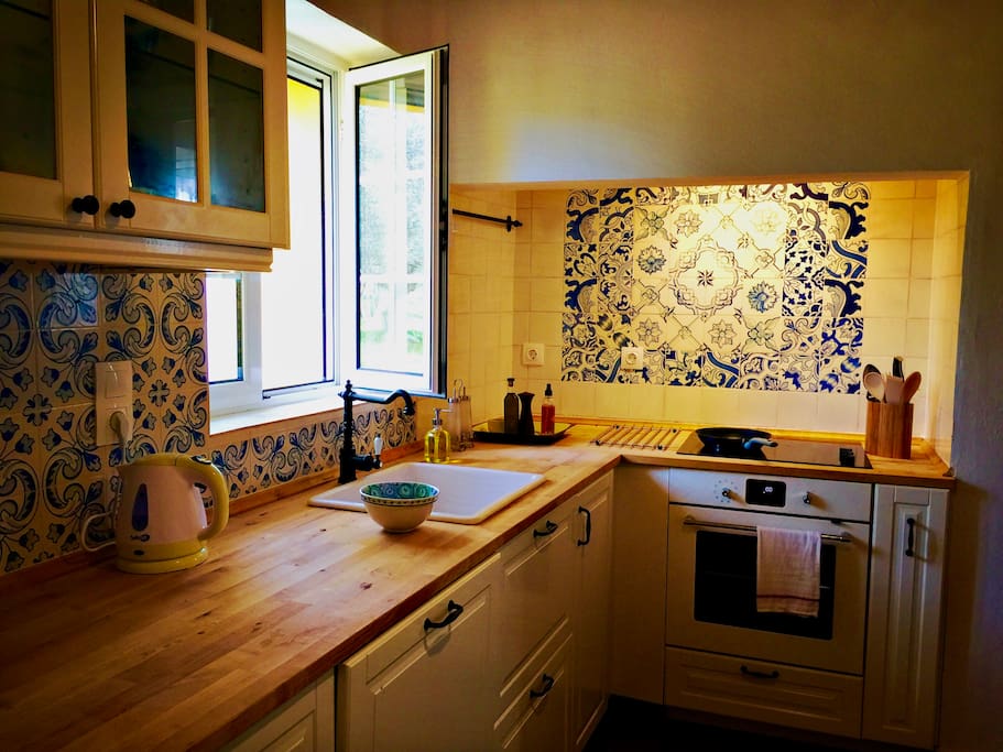 The cottage's kitchen is fully equipped, with hand-painted azulejos, new Ikea oven and dishwasher, coffee maker, kettle, and even an electric citrus juicer.