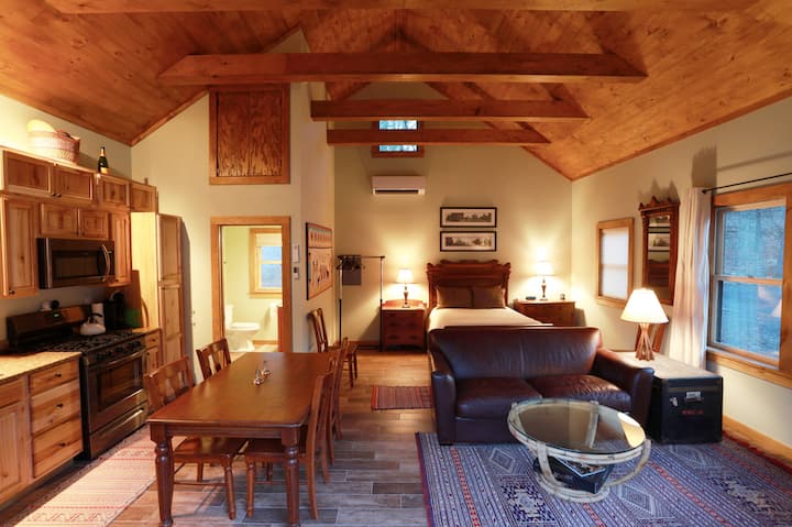 Nyumba ndogo ya mbao ni studio iliyo na kitanda cha watu wawili, jiko kamili na bafu.