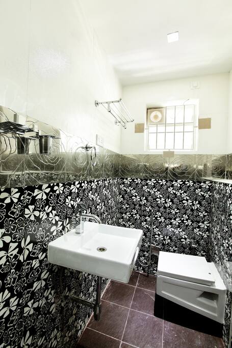 Separate bath Room with elite bath fittings decorated with flower printed cosmo tiles with free toiletries