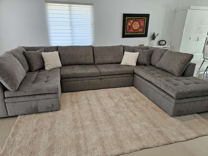 Livingroom with sectional that converts into an additional bed