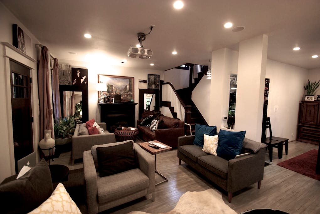 Wide angle photo of living room with stairs