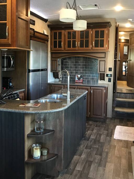Full kitchen with microwave, refrigerator, oven, coffee machines, etc.