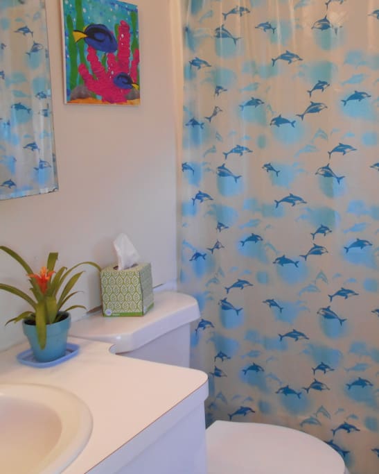 private bathroom with tub, shower and a window