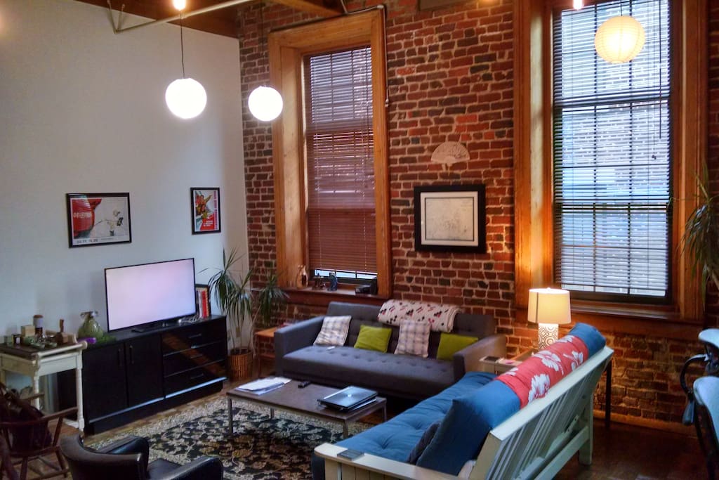 Common Room with exposed brick walls, timber frame and parquet wood floors