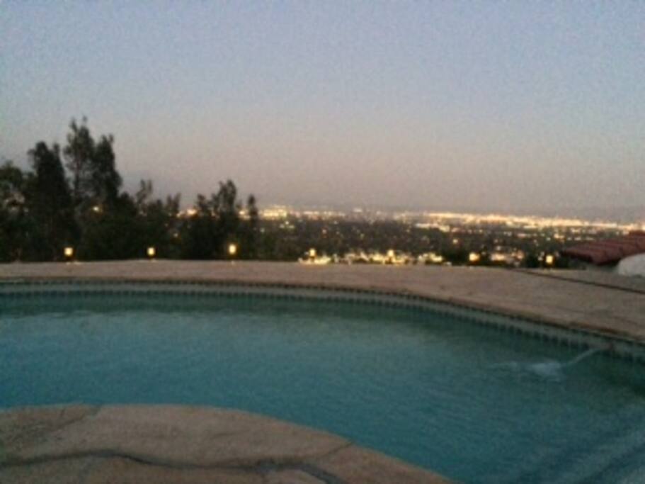 View looking out from the pool house over the pool.