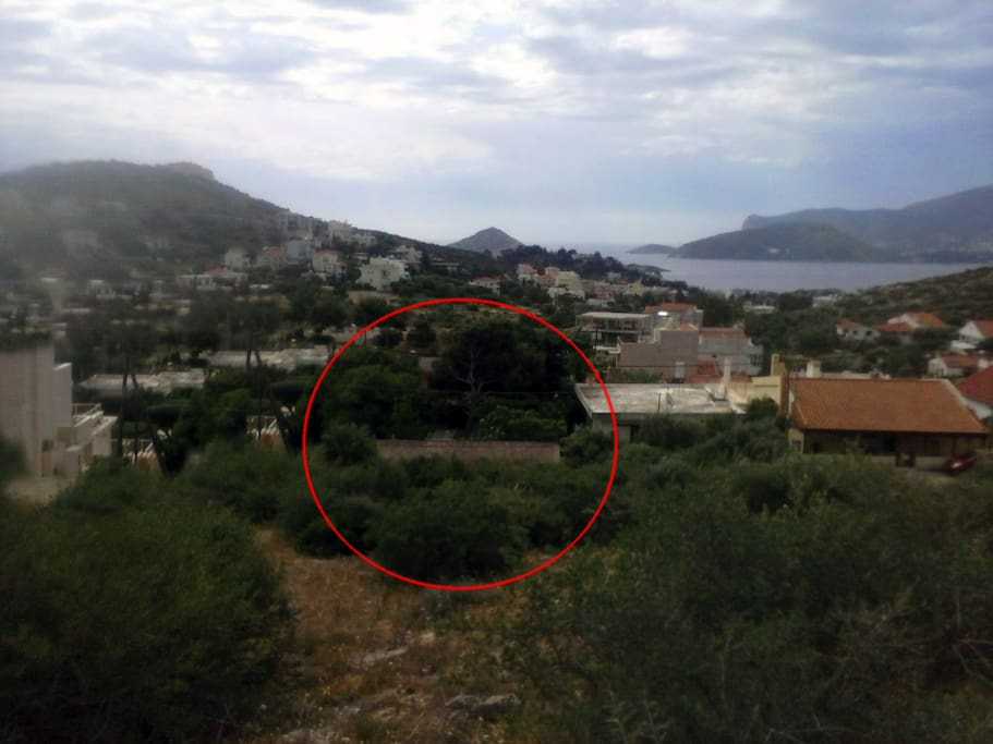 View of the house from the back mountain. With the red circle, the location of the house