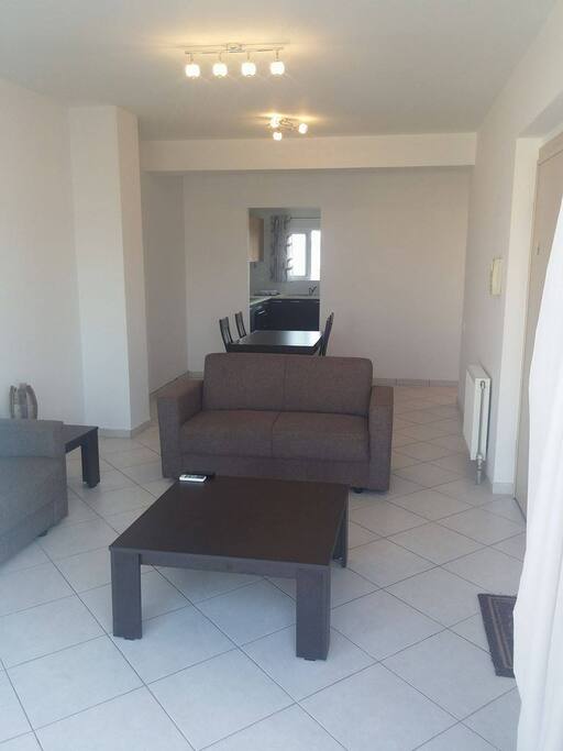 Living Room, Equipped with two new couches, new flat screen TV, new dinning table and Air Condition Unit.