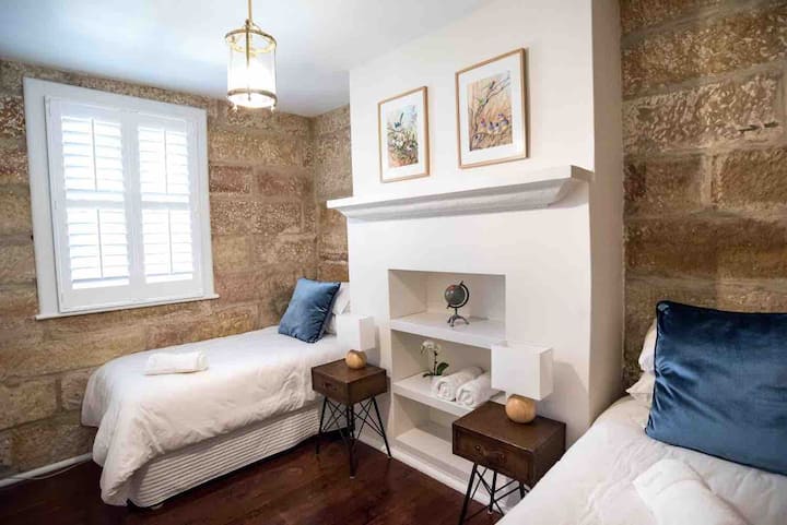 Bedroom 2 - Original sandstone walled bedroom with quiet aircon, two  comfortable hotel quality single beds and luxury bed linen.  Original window facing sunny, quiet and leafy courtyard.