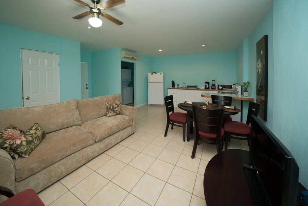 kitchen and family room open concept and door to one of the two balconies.