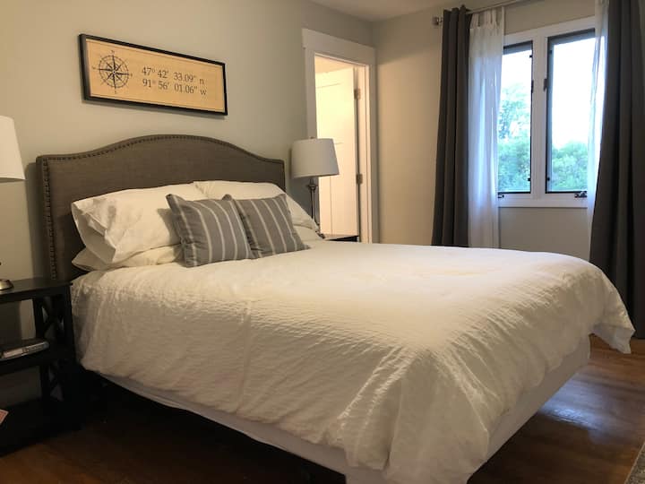 Master bedroom with views to the back yard and attached master bathroom.