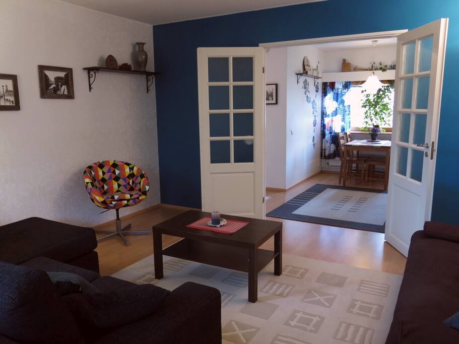 Living room is connected to the dining area with beautiful wooden double doors.