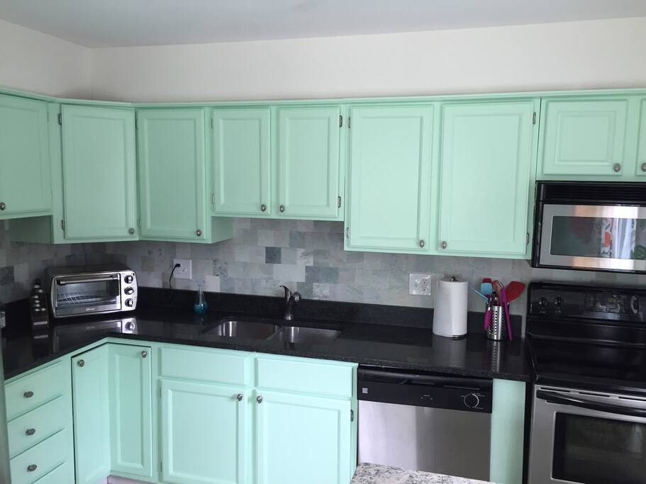 Bright and happy kitchen with stainless steel appliances.