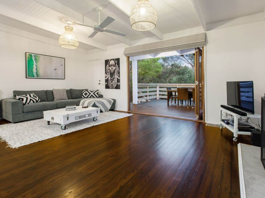 Lounge room looking onto the front balcony and outdoor dining area