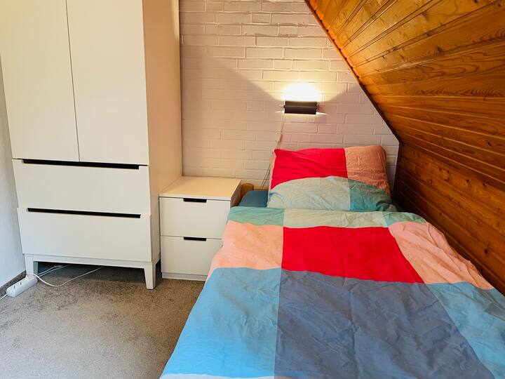 Deuxième chambre au rez-de-chaussée avec deux lits simples (adaptés aux enfants)