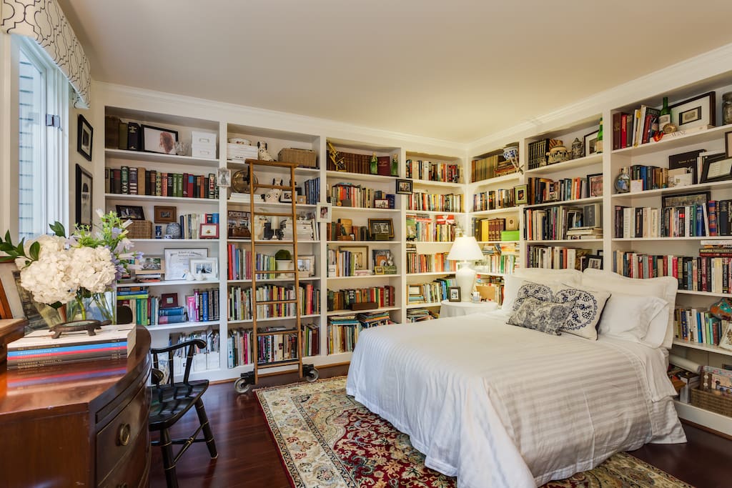 Private library suite with king bed surrounded by the most charming books