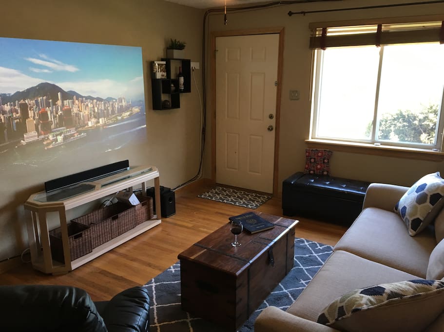 The living room featuring a large projector screen-perfect for sports or movies!