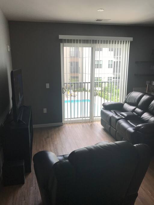 Power reclining sofa and chair along with Juliet balcony, overlooking the swimming pool.