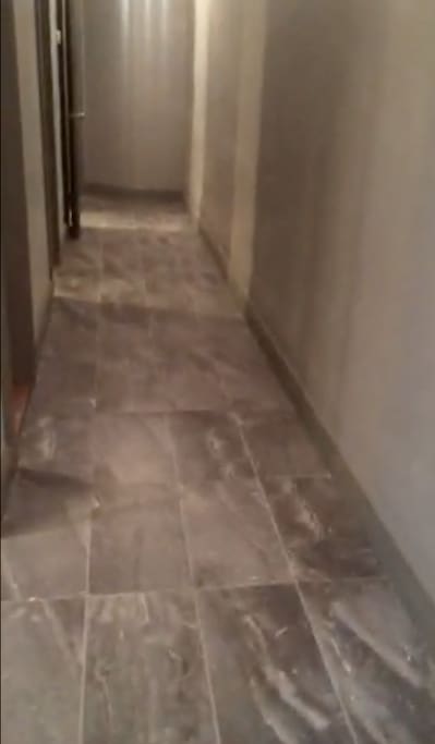 Video Stillshot of facing end of hallway