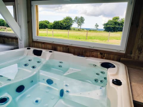 cottage with a hot tub and playground
