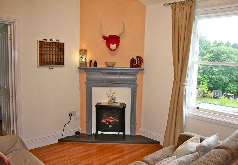 Cosy living room with view of surrounding woodland