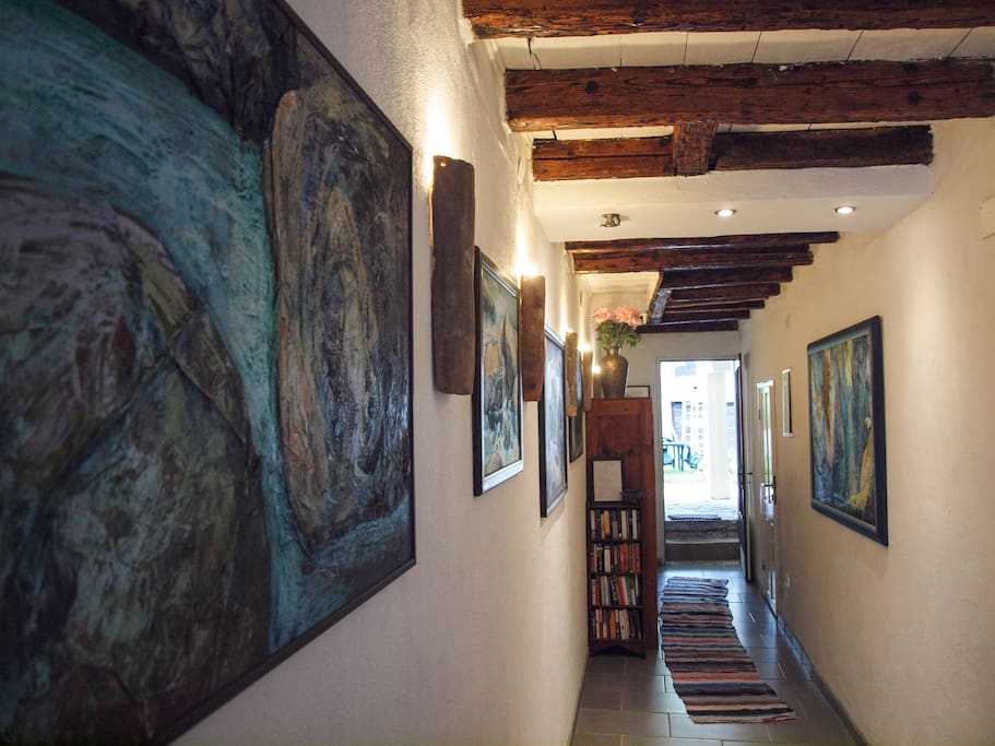 The entrance hallway filled with Jana's Dolenc's paintings of the Soca Valley