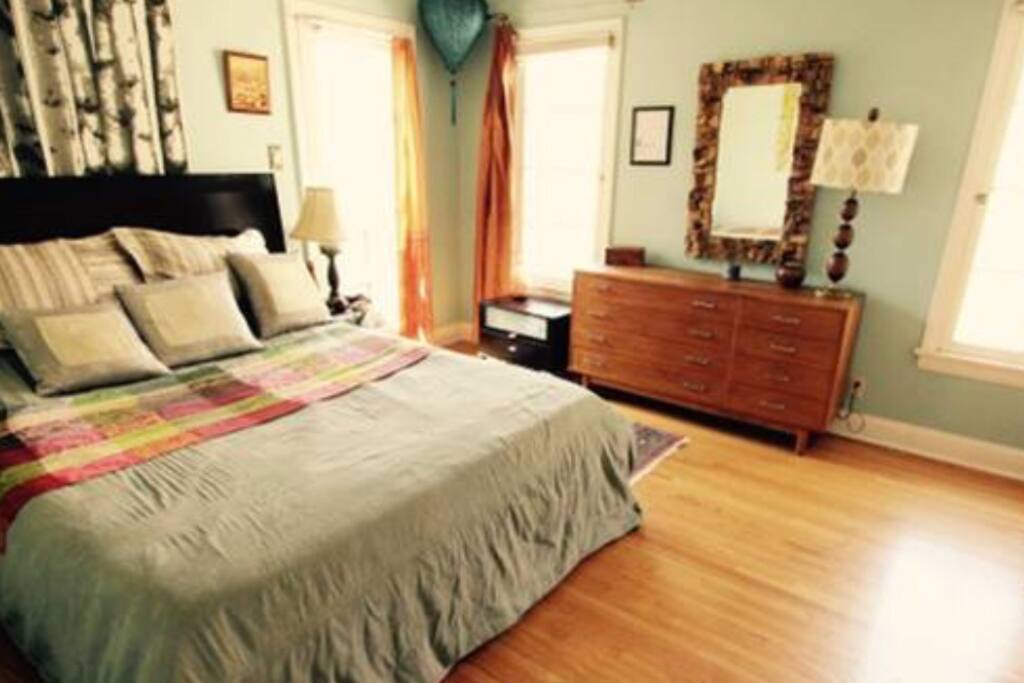 The bedroom with its own French door entrance and two more windows.