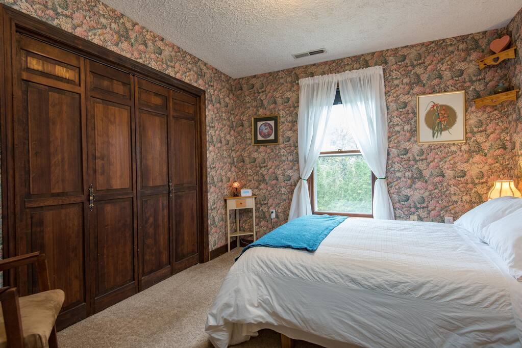 Your view toward the east. The closet houses your towels and extra blankets. There's a ceiling fan, and a newer chair.