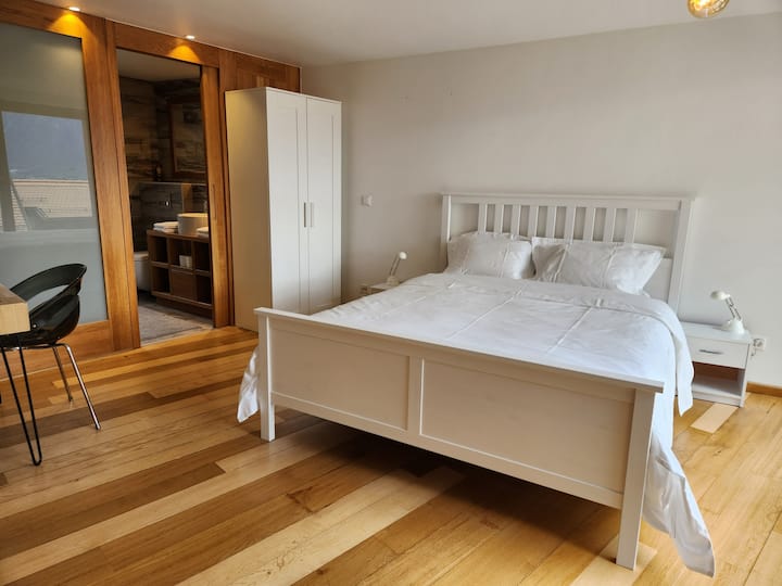 Bedroom with a mountain view, automated shutters and en suite bathroom.