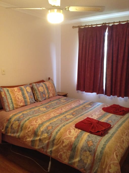 Comfortable queen bedroom with built in robes and country views