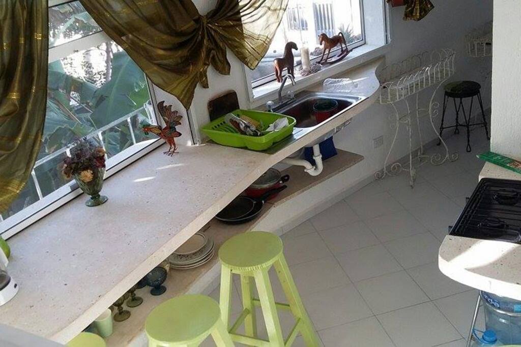 All within an arms reach, from kitchen utensils to bananas and natural herbs from second level garden