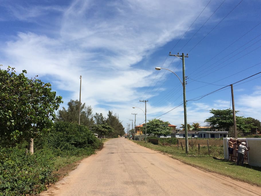 The street in between the house and the beach