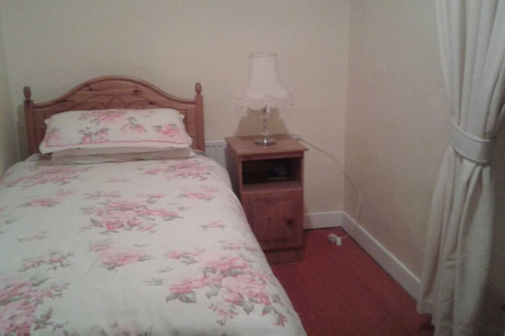 Single bed with shared bathroom