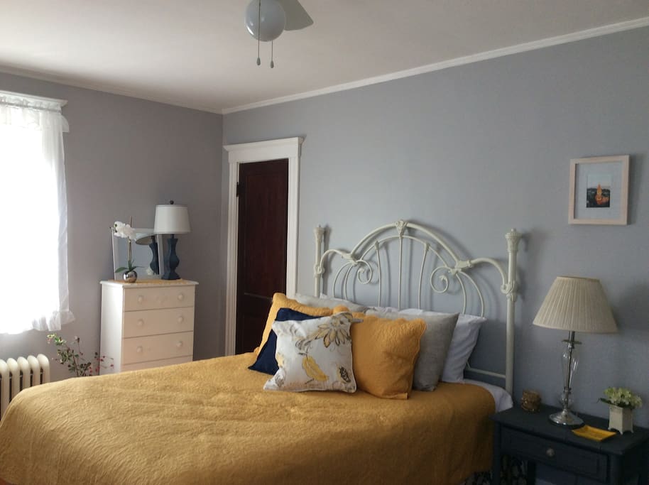 Close up picture of queen bed in "The Grey Room".