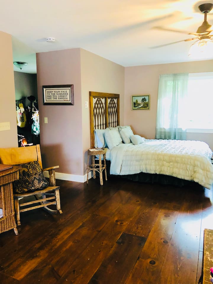 Comfortable Queen size bed with natural light.