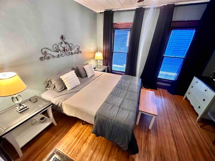 Calm and relaxing master bedroom with a king memory foam mattress, blackout curtains, and a sound machine so you have nothing but restful sweet dreams in this beautiful space with original wood.