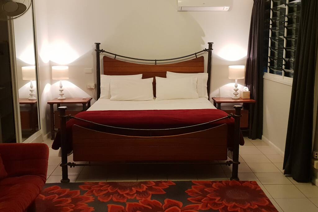 Huge master bedroom with TV & couch, adjacent to the bathroom.