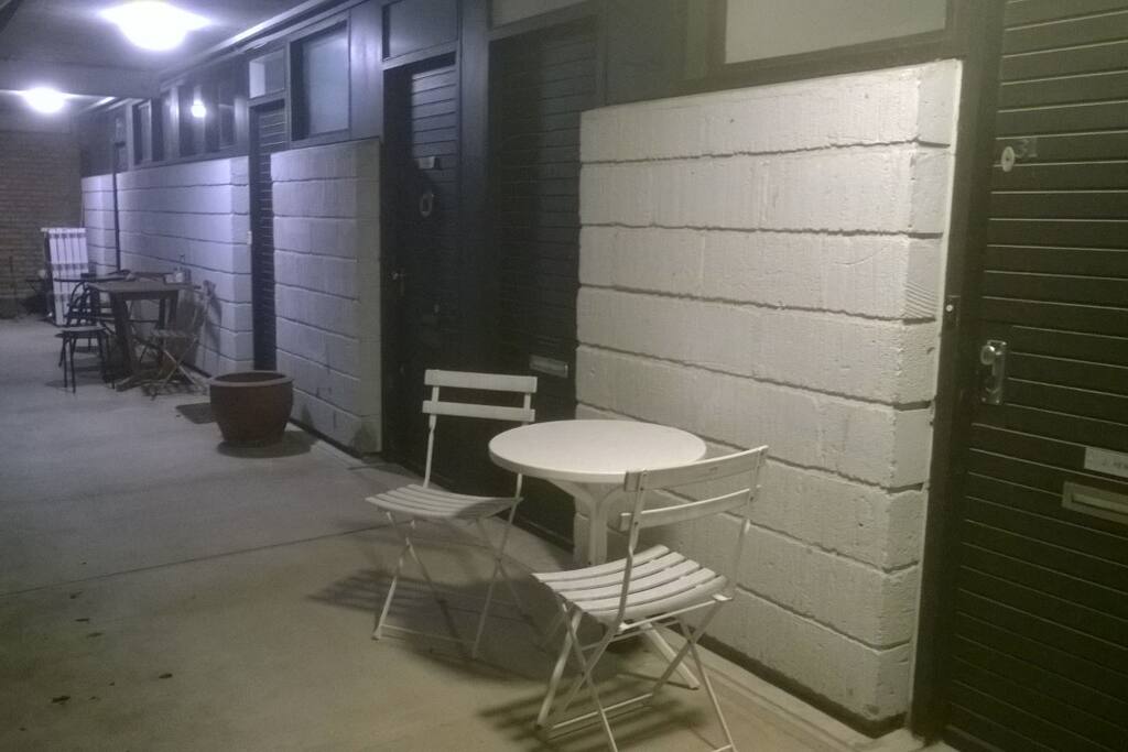 Just outside the apartment. You are free to use the little table and chairs.