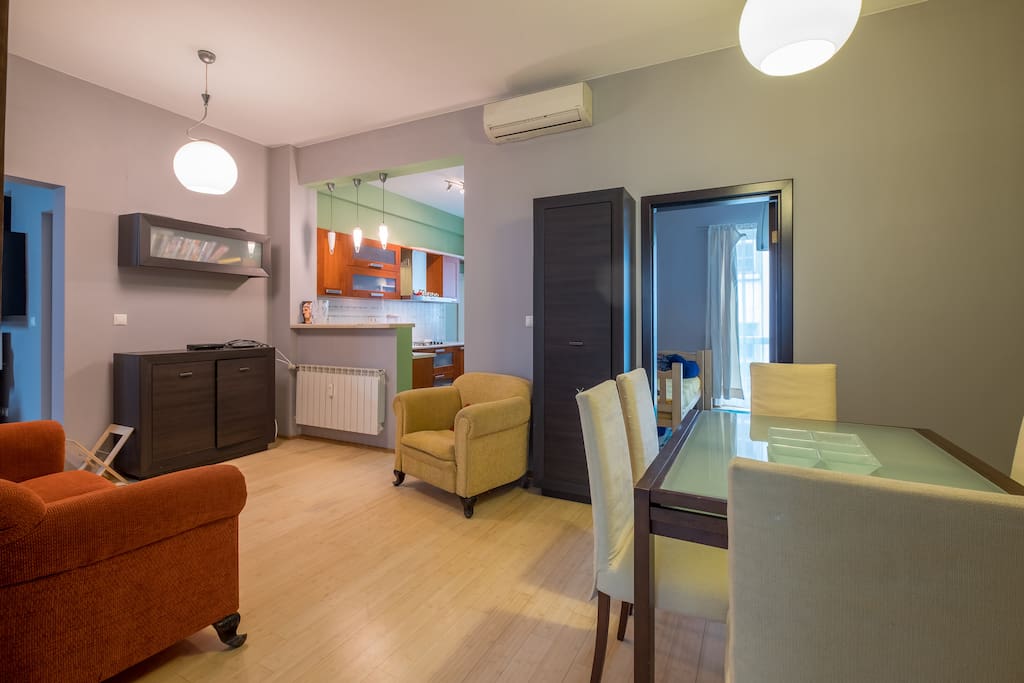 Living Room / Dining Area / Entrance to Second Bedroom / Kitchen. There is now a TV on the sideboard near the Kitchen.